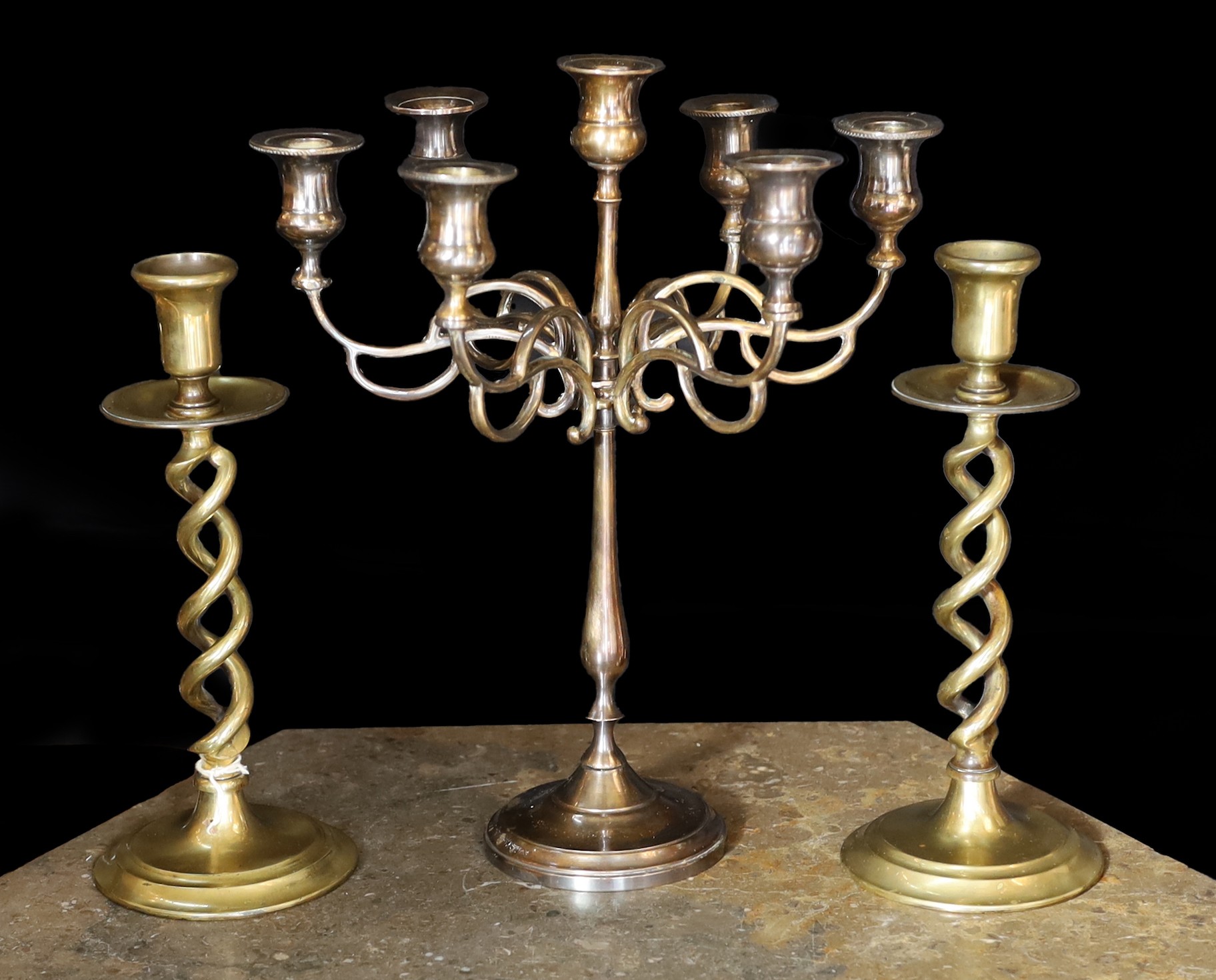 A pair of Victorian brass spiral twist candlesticks and a later seven light candelabrum, candlesticks 27cm. candelabrum 32cm